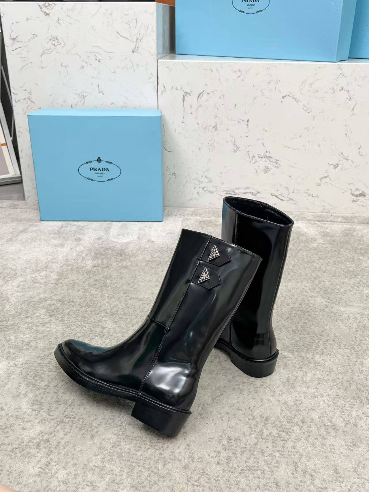 Black patent leather mid-calf boots